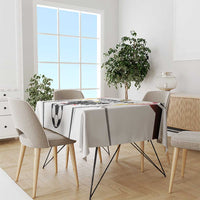 White football tablecloth on dining table with soccer ball print and emblem accents