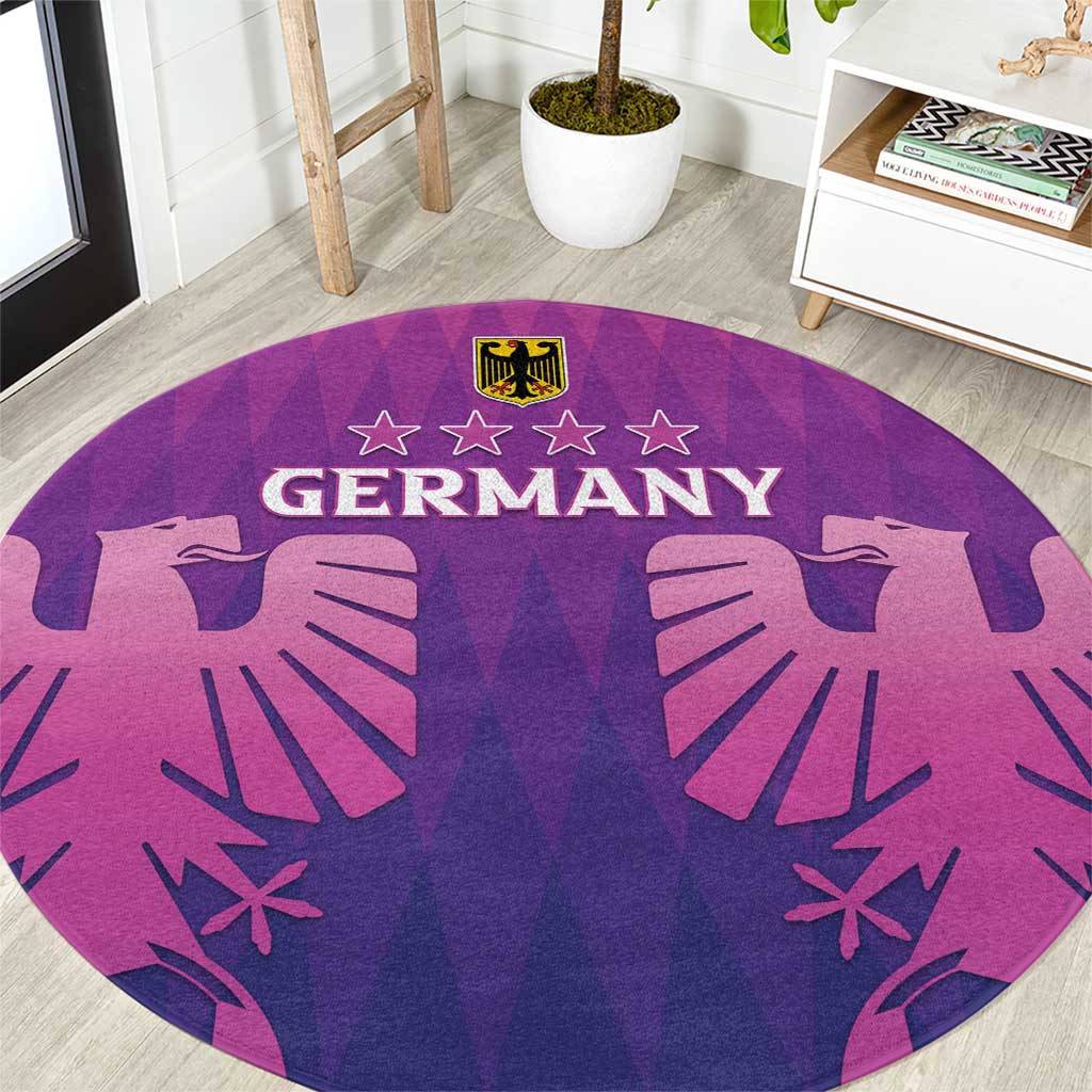 Close view of round football carpet showing Germany text, purple-pink design, and gold shield