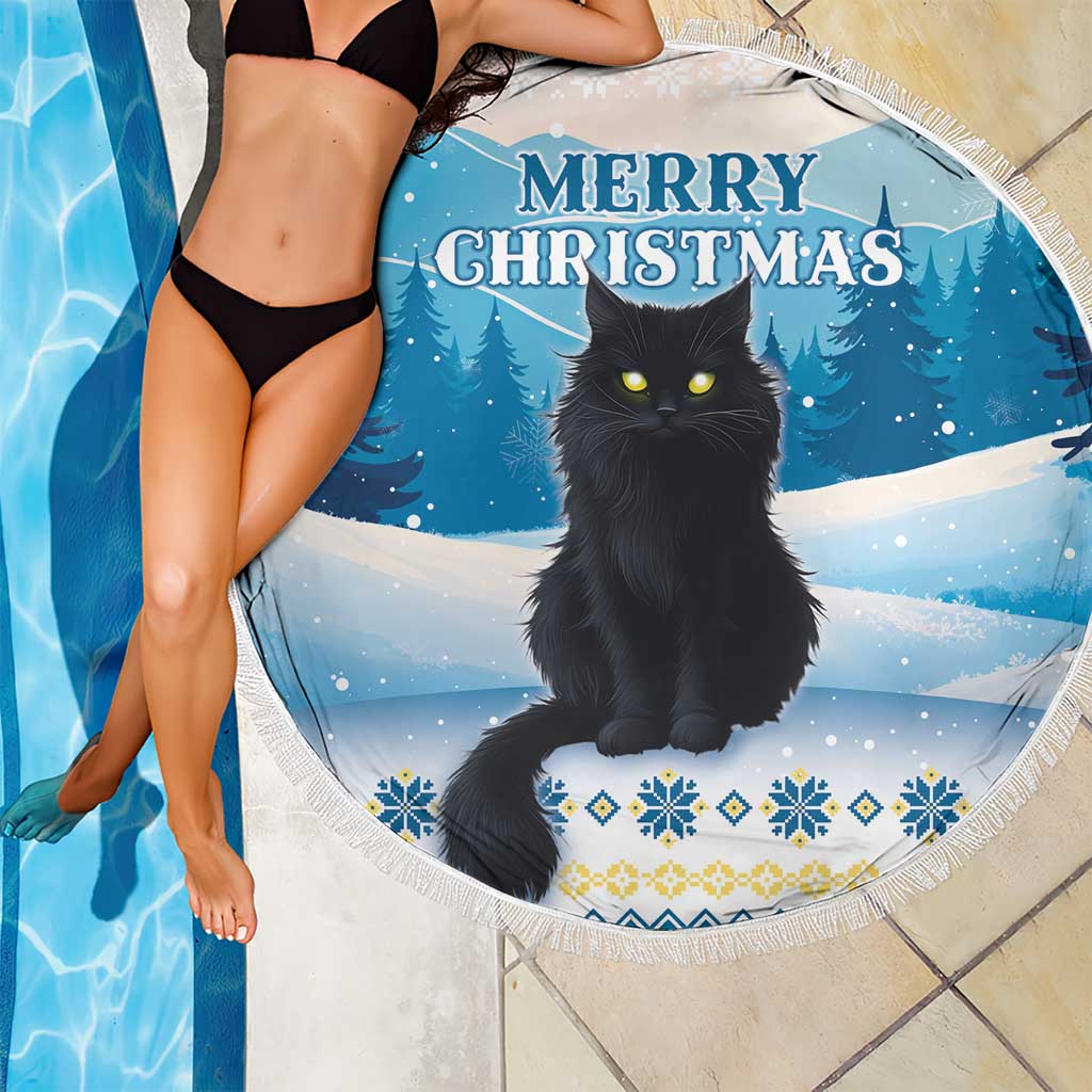 Blue round beach blanket with black cat and Merry Christmas text, fringe edge over swimsuit