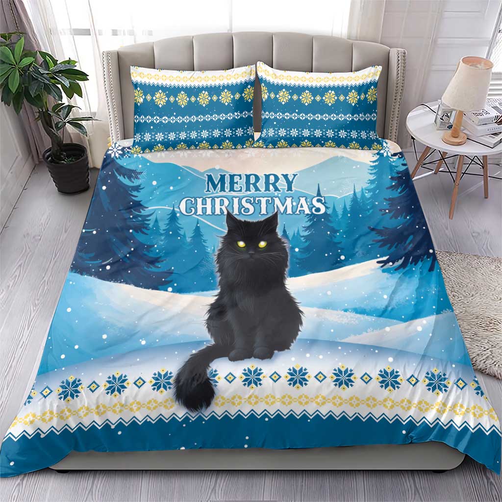 Blue duvet cover and two pillowcases featuring a sitting black cat in snowy trees scene