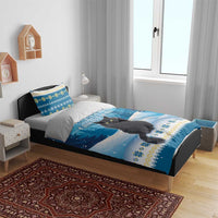 Blue Christmas cat bedding set with duvet cover and two pillowcases on a wooden bed frame