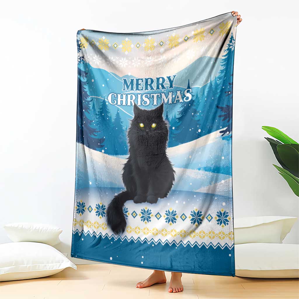 Blue cat Christmas throw blanket held up, 'MERRY CHRISTMAS' over snowy forest scene