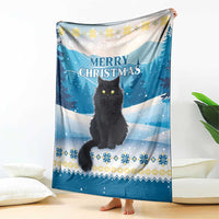 Blue cat Christmas throw blanket held up, 'MERRY CHRISTMAS' over snowy forest scene