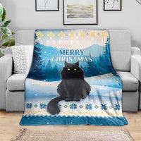 Blue cat Christmas throw blanket on sofa, 'MERRY CHRISTMAS' and snowy tree pattern