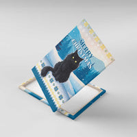 Blue canvas wall art black cat design shown at an angled view with snowy background