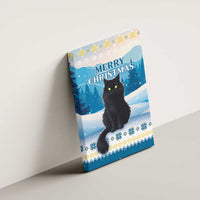Blue canvas wall art hanging on wall with black cat and winter “Merry Christmas”