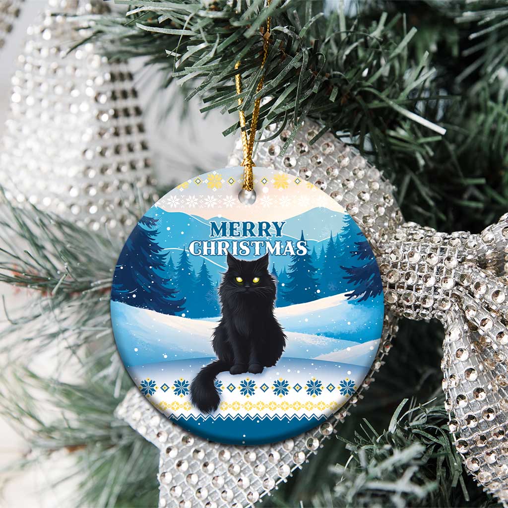 Blue round ceramic cat Christmas ornament on a tree with “Merry Christmas” text