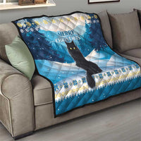 Blue quilt on sofa featuring black cat, winter trees, and “Merry Christmas” title