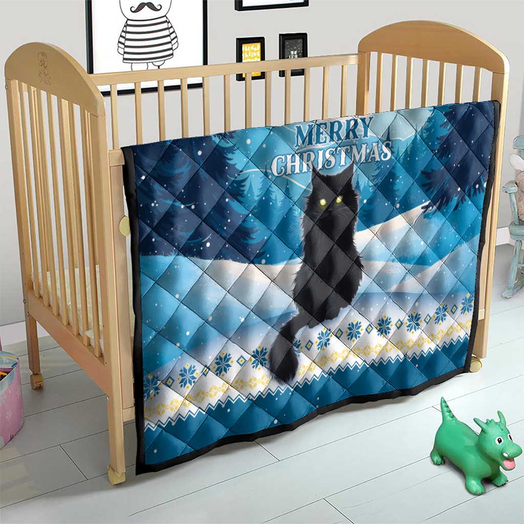 Blue quilt on wooden crib with black cat, “Merry Christmas,” and snowy patterns