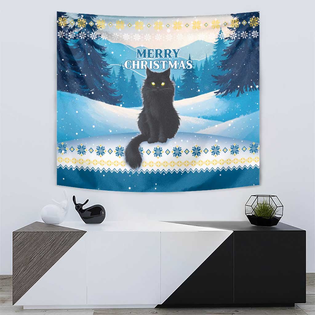 Blue tapestry with black cat on snow, pine trees, and “Merry Christmas” text