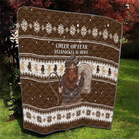 Brown quilt with festive Fair Isle design, “CHEER OR FEAR” wording, and Belsnickel artwork