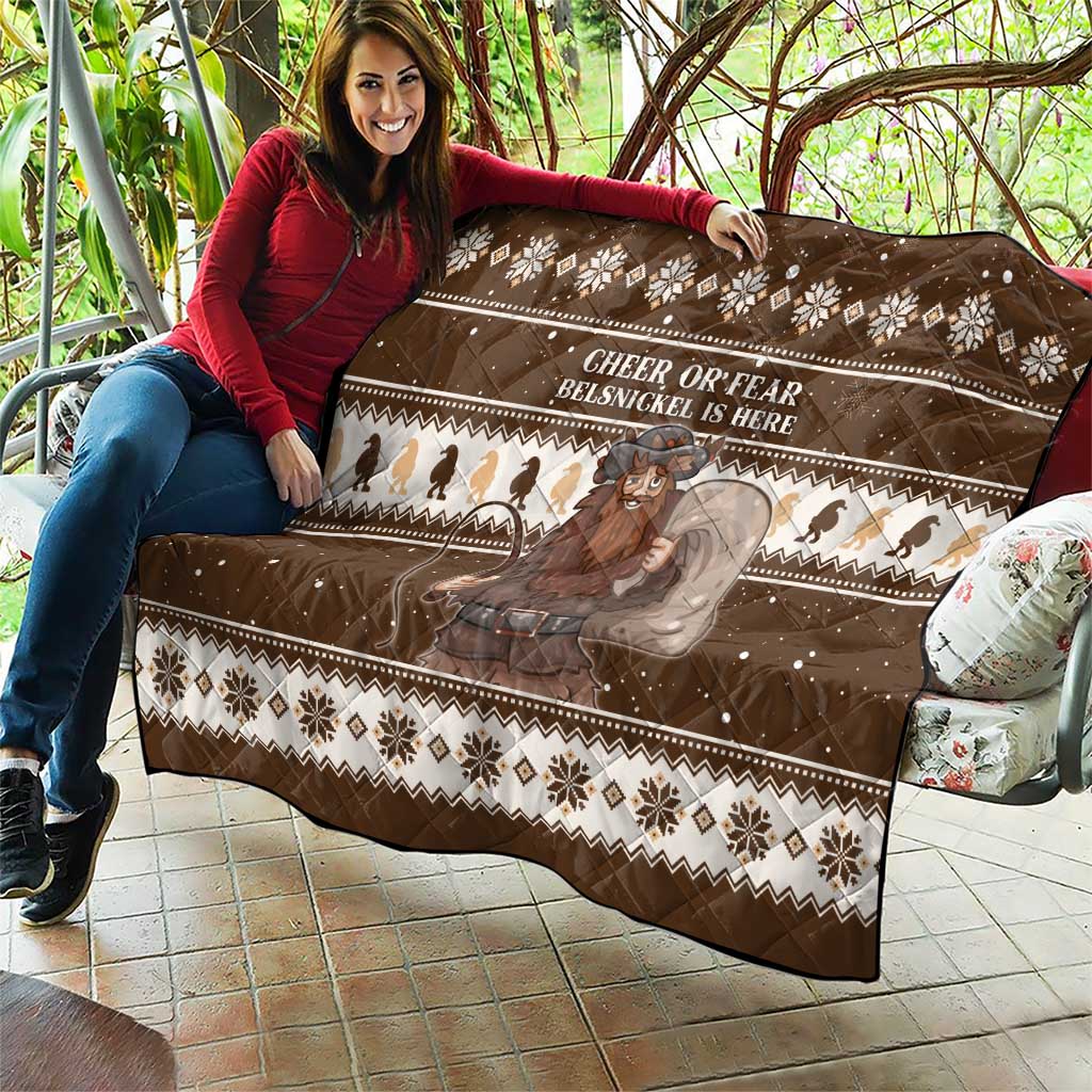 Brown Christmas quilt spread on patio furniture with snowflake borders and Belsnickel print