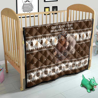 Brown Christmas quilt on a baby bed with “CHEER OR FEAR” text and Belsnickel figure