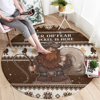Brown round Christmas rug showing Belsnickel holding a sack, zigzag trim