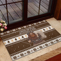 Brown rubber Christmas doormat with Belsnickel graphic and snowflake border pattern