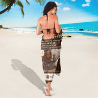 Brown printed sarong with Belsnickel artwork and repeating geometric trim