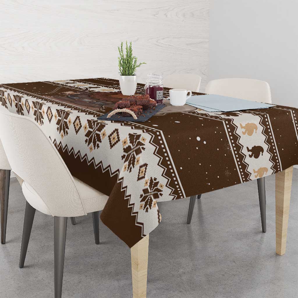 Brown holiday tablecloth with fair-isle band, snow specks, and Belsnickel illustration