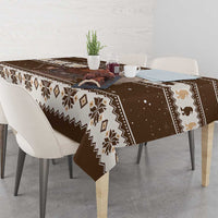 Brown holiday tablecloth with fair-isle band, snow specks, and Belsnickel illustration