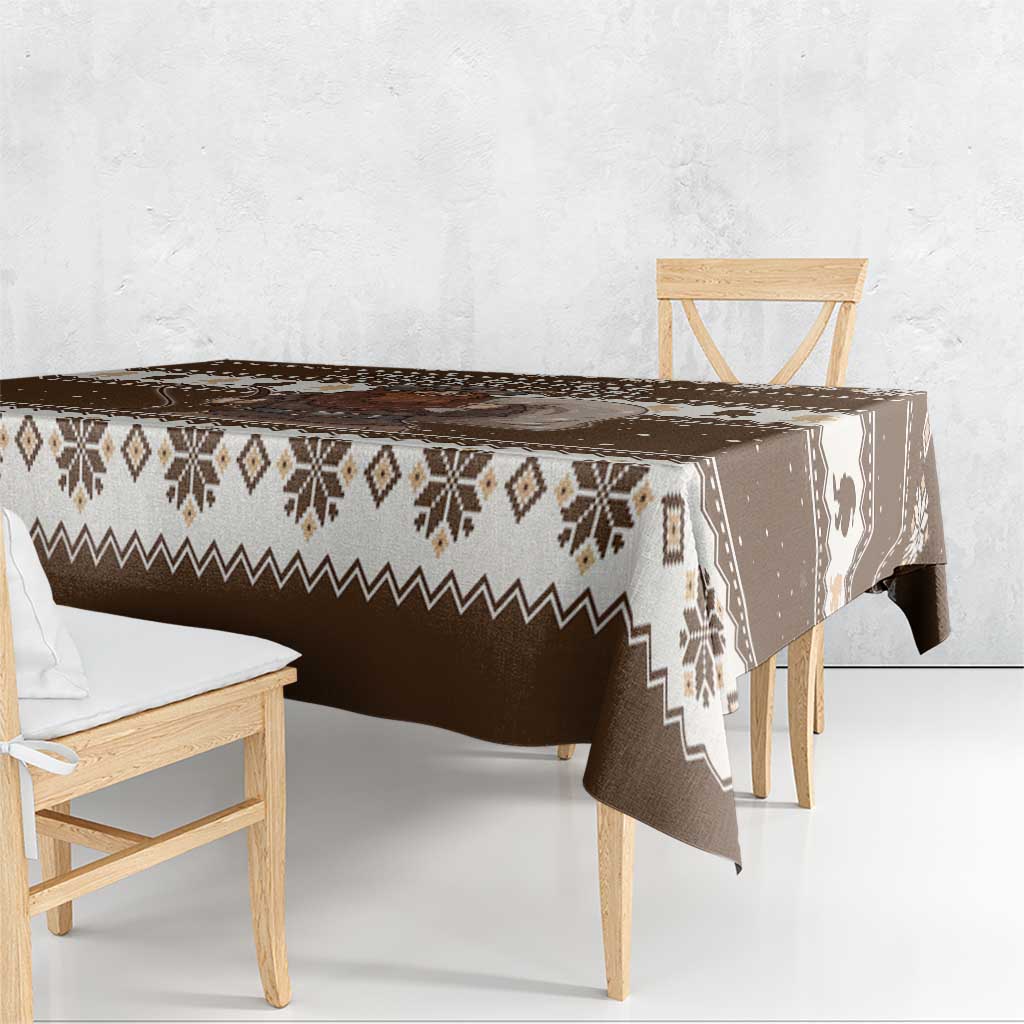 Brown holiday tablecloth with fair-isle stripes and Belsnickel print along table edge