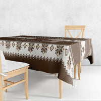 Brown holiday tablecloth with fair-isle stripes and Belsnickel print along table edge