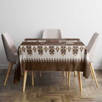 Brown holiday tablecloth with repeating fair-isle pattern and central Belsnickel scene