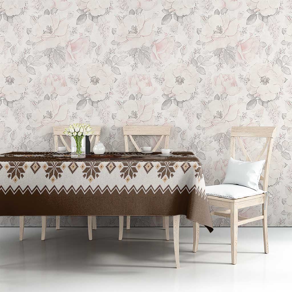 Brown holiday tablecloth with geometric border and Belsnickel motif on dining table
