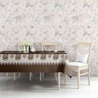 Brown holiday tablecloth with geometric border and Belsnickel motif on dining table