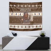 Brown tapestry with Belsnickel holding staff, white lettering, and reindeer border