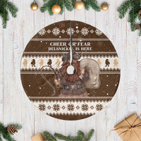 Round brown tree skirt with white fringe, Belsnickel graphic and 'Cheer or Fear' text.