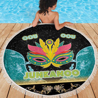 Round Junkanoo beach blanket with fringe edge, mask and 'JUNKANOO' text in center