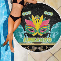 Round Junkanoo beach blanket with fringe edge, colorful mask logo and 'JUNKANOO' text