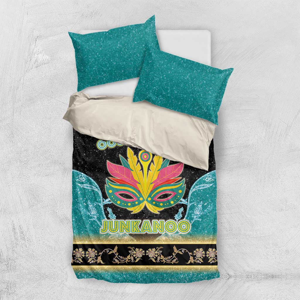 Junkanoo-themed bedding set laid flat: teal shams and black duvet with mask and gold trim