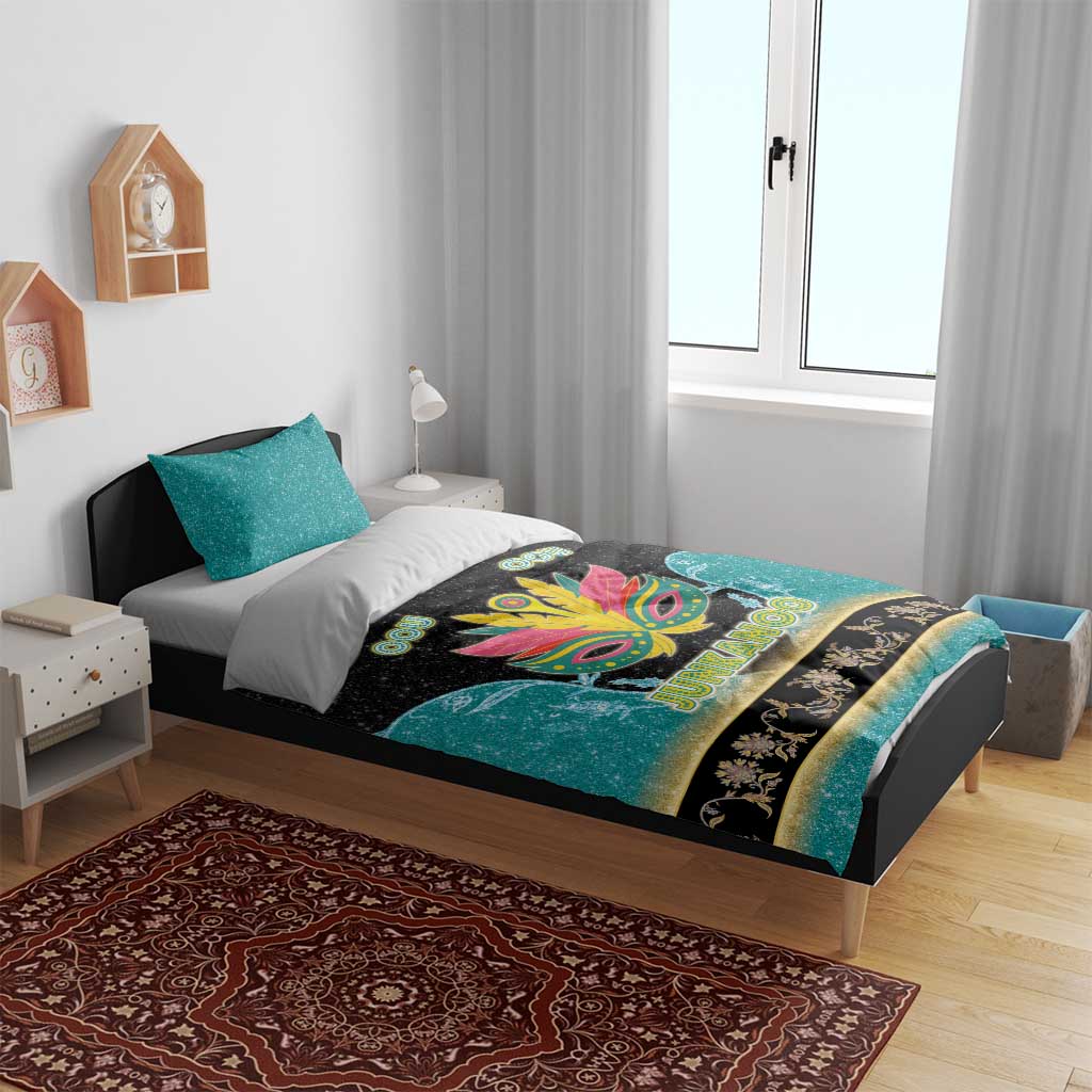 Junkanoo-themed bedding set on a bed: teal and black duvet with colorful mask artwork