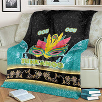Junkanoo blanket covering couch, black and teal gradient with neon mask and gold trim