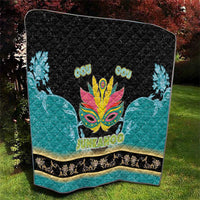 Junkanoo-themed quilt folded, black center with teal sides, carnival mask and 'JUNKANOO'