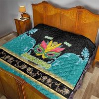 Junkanoo quilt on bed, black and teal with colorful carnival mask, 'JUNKANOO' banner