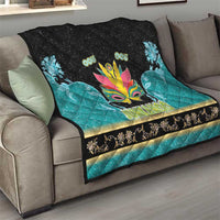 Junkanoo-themed quilt on sofa, black-and-teal with colorful carnival mask and patterned edge
