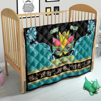 Junkanoo quilt on baby crib, black top with teal panels, colorful mask and 'JUNKANOO'