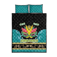 Quilt bed set featuring teal pillow shams and black quilt with Junkanoo mask graphic