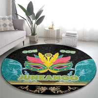 Round black area rug featuring bright Junkanoo mask with JUNKANOO lettering and teal flourishes