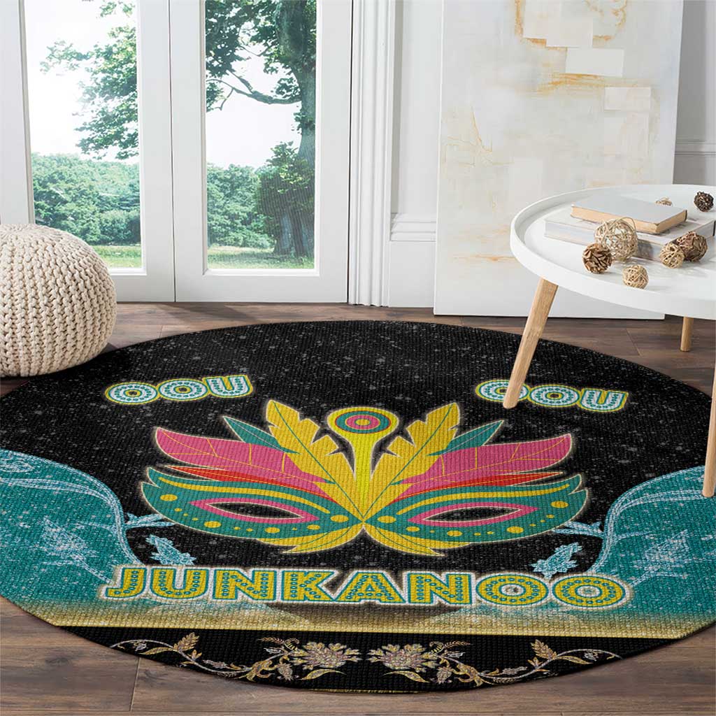 Round black rug with large colorful Junkanoo mask, JUNKANOO text, teal corner shapes