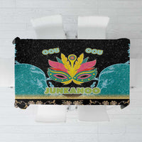 Rectangular tablecloth with black, teal, and gold gradient; colorful Junkanoo-style mask graphic