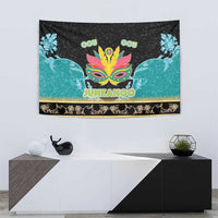 Junkanoo tapestry on wall with teal bird figures, colorful mask, and gold border