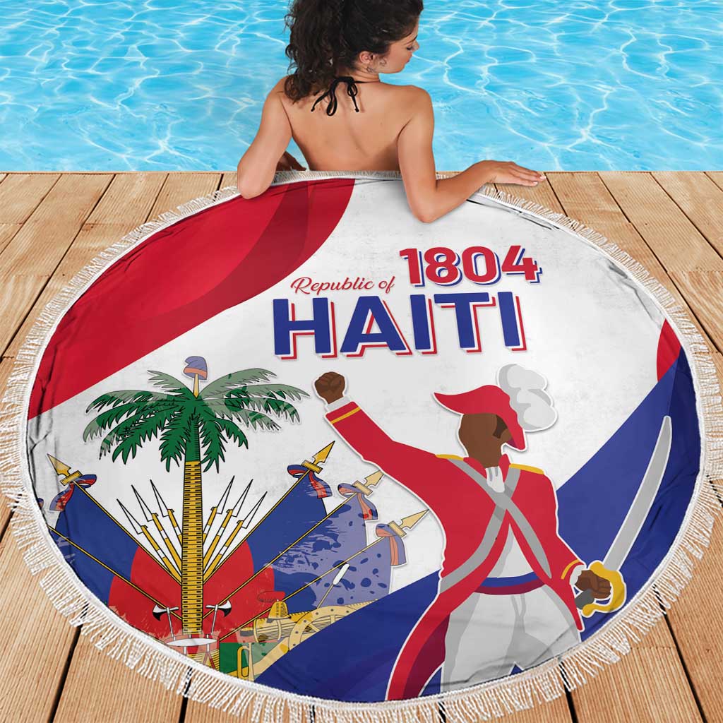 Round beach blanket with fringed edge, white fabric, Haiti 1804 flag graphic; worn