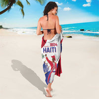 Haiti independence sarong tied at waist, white with red-blue flag and '1804 HAITI' text.