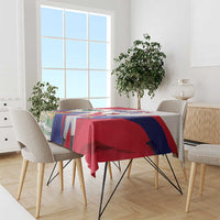 Flag-pattern tablecloth draped over dining table, red, blue, and white