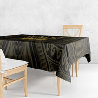 Black and gold printed tablecloth with draped corners and geometric motifs across the top.