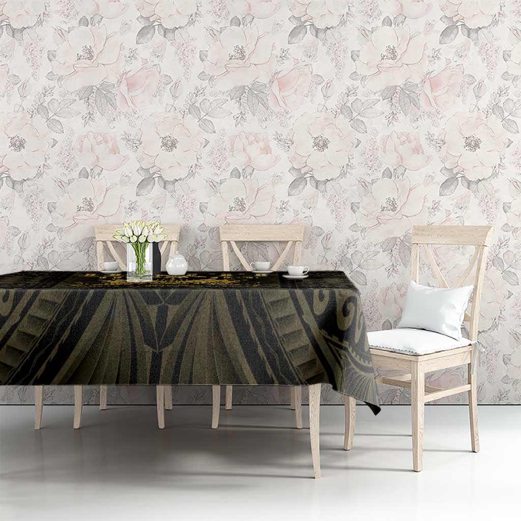 Black and gold tablecloth with ornate pattern draped on a dining table with chairs.