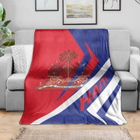 Haiti flag blanket draped on a gray sofa, red white and blue coat of arms print