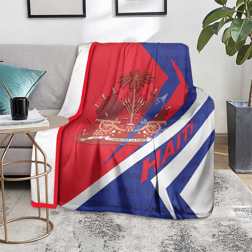 Haiti flag blanket on a gray chair, red white and blue coat of arms graphic